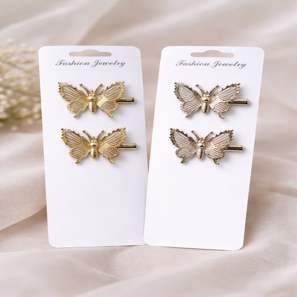 Butterfly-shaped hair clips on white cards with 'Fashion Jewelry' text, on a beige fabric background.